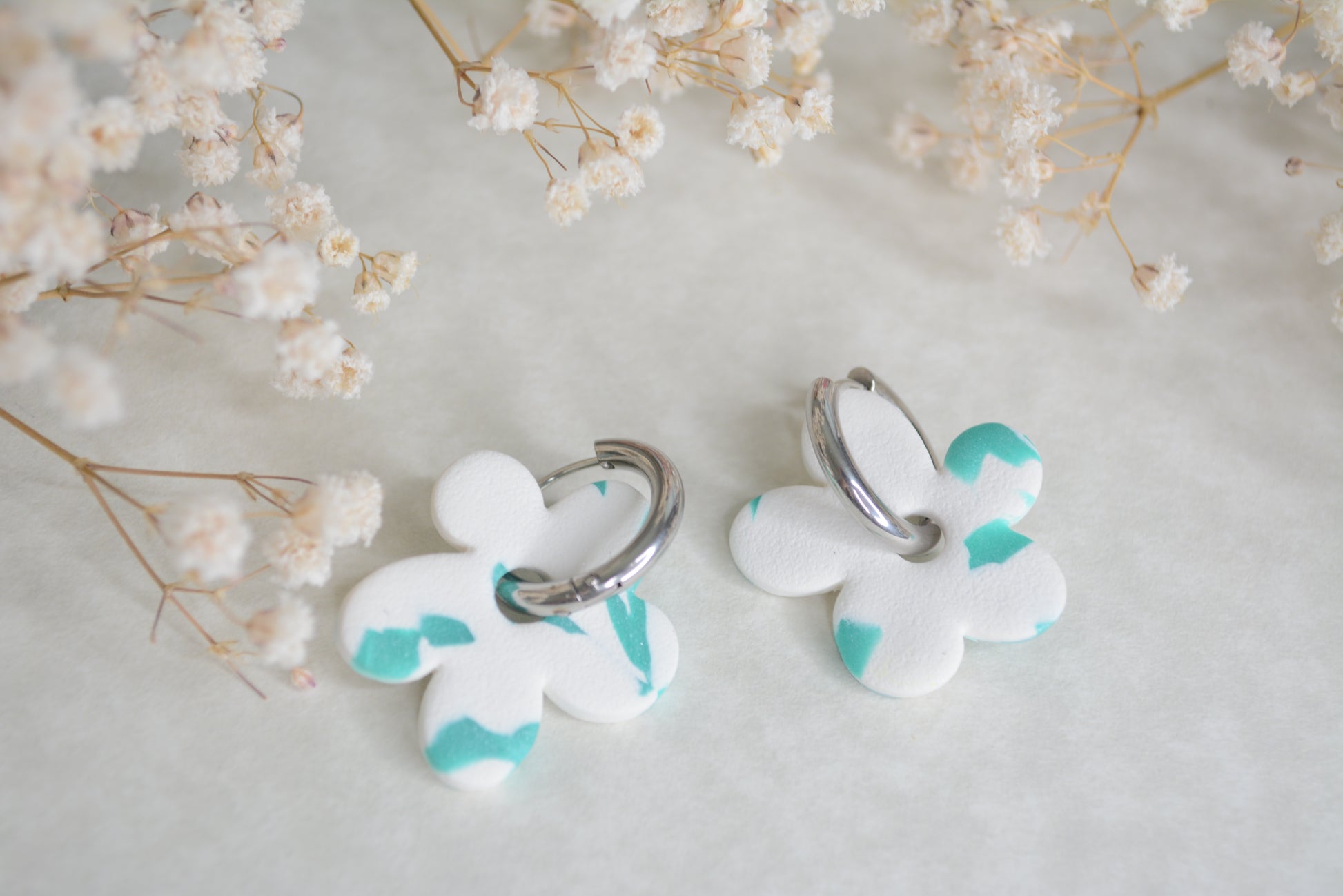 silver chunk hoops with a blue and white flower. You can use just the hoop or the hoop with the flower that you choose. 