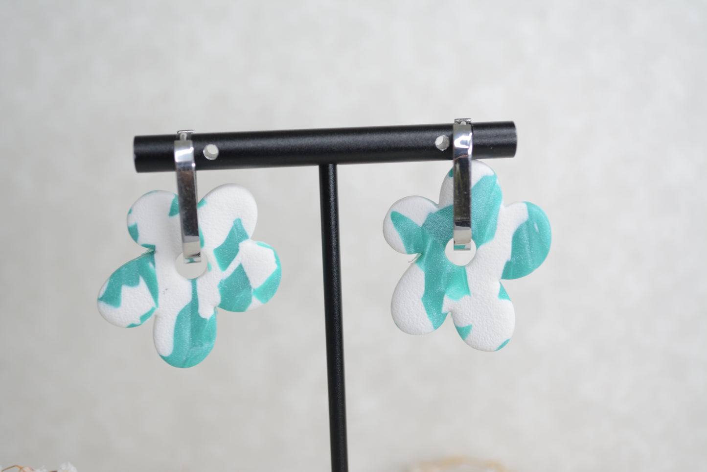 oval silver hoop with a blue and white polymer clay earrings.