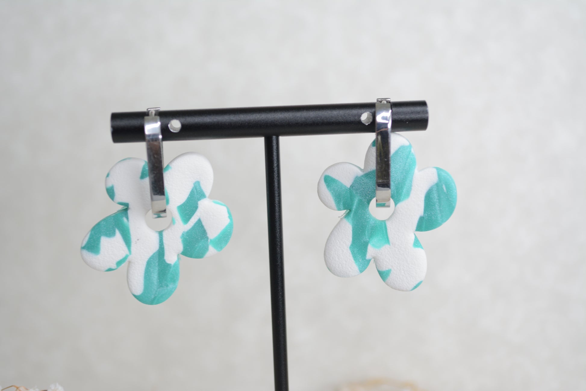 oval silver hoop with a blue and white polymer clay earrings.