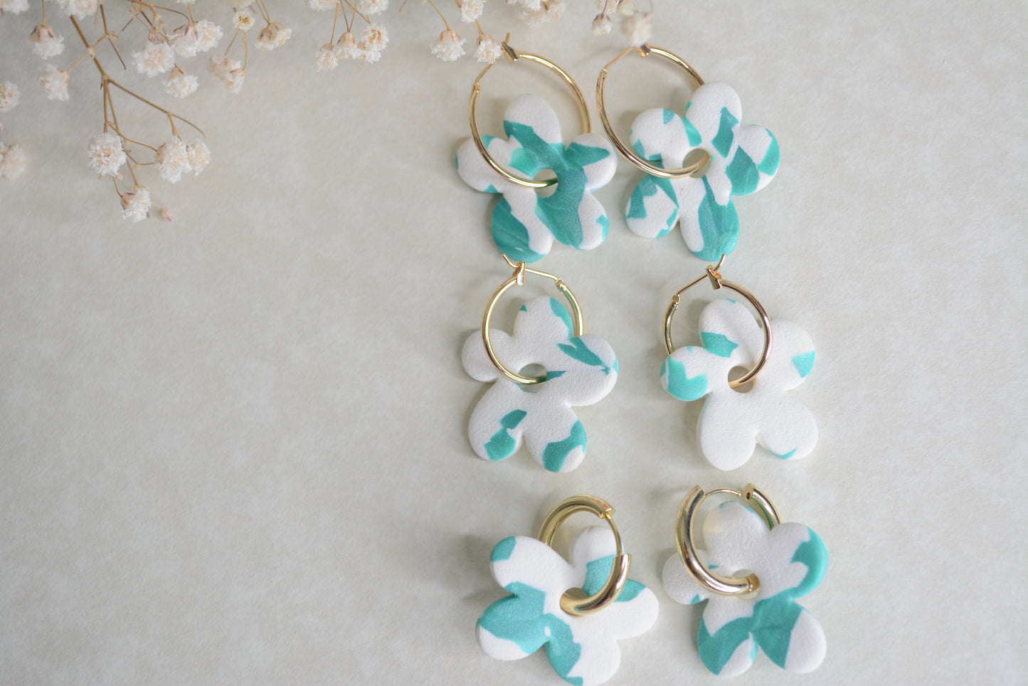 Gold hoops, 3 different sizes. big, medium and chunk medium earrings. all with blue and white polymer clay earrings.  