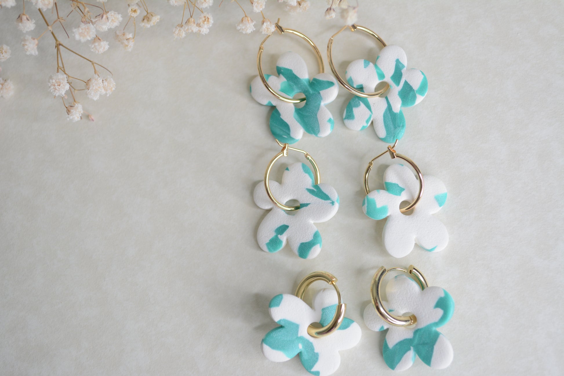 Gold hoops, 3 different sizes. big, medium and chunk medium earrings. all with blue and white polymer clay earrings.  